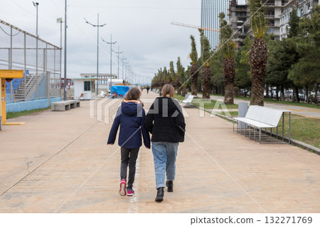 Pretty young girls in season jacket walking down outdoors Pretty young girls in season jacket walking down outdoors 132271769