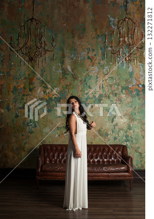 Stylish young female model brunette looking at camera indoor, full length portrait Stylish young female model brunette looking at camera indoor, full length portrait 132271812