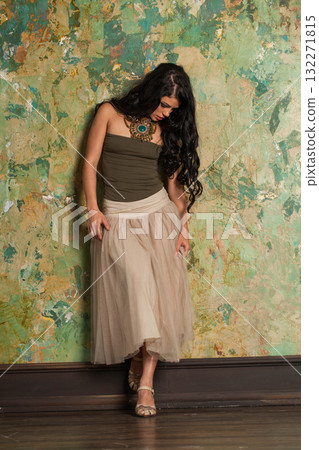 Beautiful healthy woman wearing fashionable dress on green painted background indoor Beautiful healthy woman wearing fashionable dress on green painted background indoor 132271815