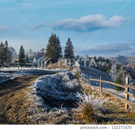 Winter coming. Last days of autumn, morning in mountain countryside peaceful picturesque hoarfrosted scene. Dirty road from hills to the village. Ukraine, Carpathian mountains. Winter coming. Last days of autumn, morning in mountain countryside peaceful picturesque hoarfrosted scene. Dirty road from hills to the village. Ukraine, Carpathian mountains. 132271870
