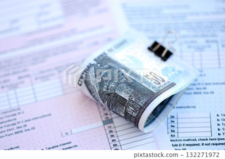 Egyptian pound money bills on tax form close up. Taxation and accounting concept Egyptian pound money bills on tax form close up. Taxation and accounting concept 132271972