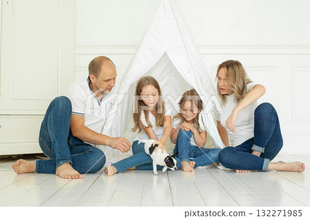 Portrait of family having fun with puppy dog pet at home Portrait of family having fun with puppy dog pet at home 132271985