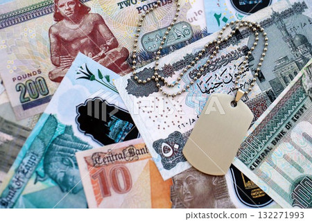 Egyptian pound currency money bills and military token close up. The concept of army service 132271993