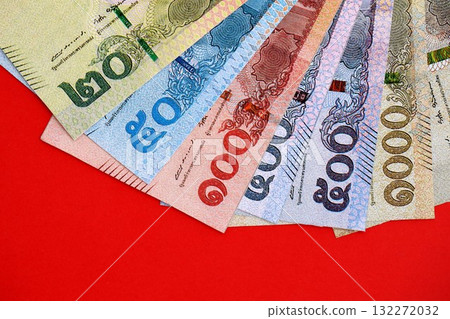 Thai baht money bills in big amount on red close up. Finance and banking concept Thai baht money bills in big amount on red close up. Finance and banking concept 132272032