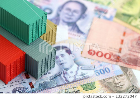 Thai baht currency money bills and toy cargo containers close up. The concept of shipping and logistics Thai baht currency money bills and toy cargo containers close up. The concept of shipping and logistics 132272047