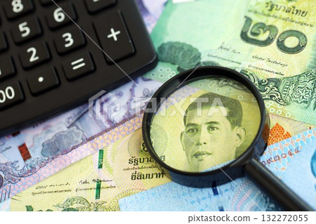 Thai baht currency money bills and calculator with magnifying glass close up. The concept of taxation and money count 132272055