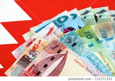 Bahraini dinar currency money bills lies on flag close up. The concept of business and investment Bahraini dinar currency money bills lies on flag close up. The concept of business and investment 132272101