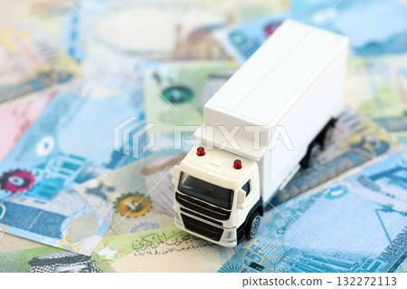 Bahraini dinar currency money bills and toy delivery truck close up. The concept of delivery and logistics 132272113