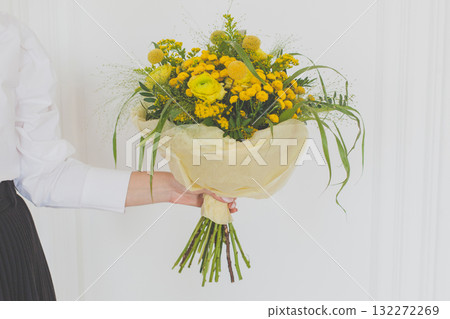 Yellow flower in hand on white background Yellow flower in hand on white background 132272269