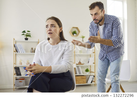 Conflict of couple at home, woman looking away as angry partner scolding 132272296