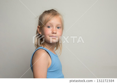 Cute young child girl standing against white wall background Cute young child girl standing against white wall background 132272384