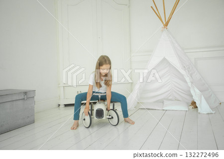 Playful little girl child driving toy car at home 132272496