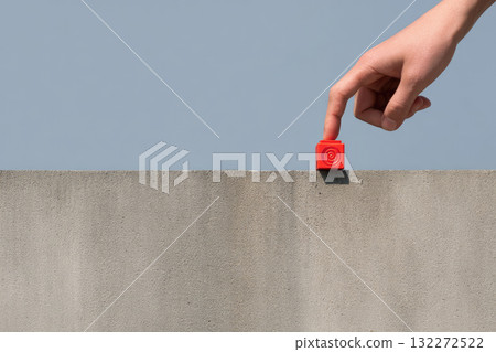 Hand adjusting red emergency beacon on modern concrete roof minimal style clear blue sky background safety concept calm atmosphere outdoor urban setting alert device contemporary architecture Hand adjusting red emergency beacon on modern concrete roof minimal style clear blue sky background safety concept calm atmosphere outdoor urban setting alert device contemporary architecture 132272522