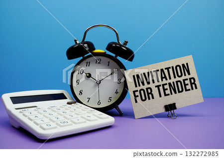 Invitation For Tender text with calculator and alarm clock on blue and purple background Invitation For Tender text with calculator and alarm clock on blue and purple background 132272985
