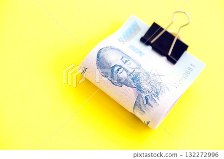 Vietnamese dong money bills in big amount close up on yellow. Finance and banking concept Vietnamese dong money bills in big amount close up on yellow. Finance and banking concept 132272996