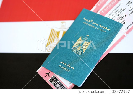 Egyptian passport and boarding pass tickets on flag close up. The concept of travel and vacation Egyptian passport and boarding pass tickets on flag close up. The concept of travel and vacation 132272997