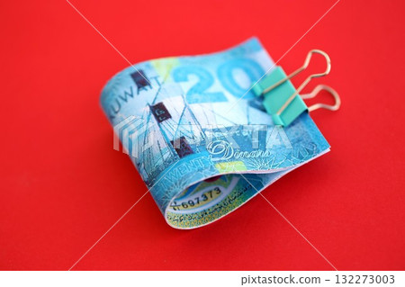 Kuwaiti dinar money bills in big amount on red close up. Finance and banking concept Kuwaiti dinar money bills in big amount on red close up. Finance and banking concept 132273003