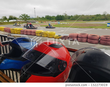 Go karting crash helmets in a row outdoors 132273019