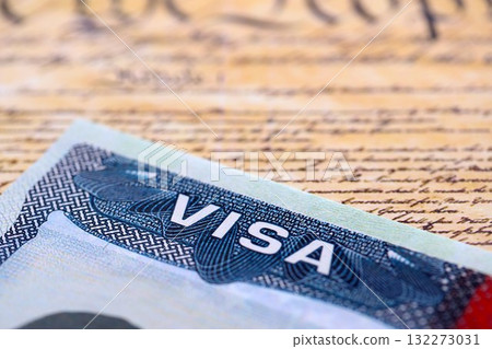 US visa stamped on a passport page with USA Constitution page background. Travel and immigration concept 132273031