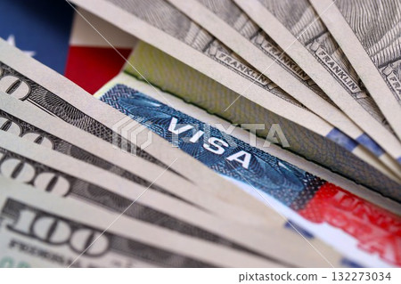 Work and Travel VISA, Immigration with Dollars banknotes on United States of America flag close up Work and Travel VISA, Immigration with Dollars banknotes on United States of America flag close up 132273034