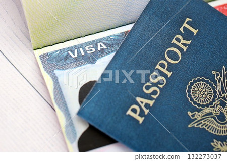 USA visa in an open passport page and United States passport cover on background close up USA visa in an open passport page and United States passport cover on background close up 132273037