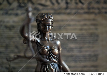 Dark scene with Lady Justice and background of US Constitution page. Lawsuit and judgement in United States of America Dark scene with Lady Justice and background of US Constitution page. Lawsuit and judgement in United States of America 132273051