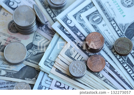 Half Dollar and one dollar coins on top of USD banknotes. Coins and paper money. US Dollar cash, finance and economy in the United States of America 132273057