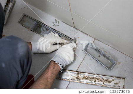 Mold damage problem in bathroom. Worker repairing sewer and bathroom drain 132273076