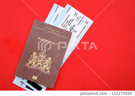 Netherlands passport and commercial airlines boarding pass tickets close up. Travel flights and avia tourism in Europe concept Netherlands passport and commercial airlines boarding pass tickets close up. Travel flights and avia tourism in Europe concept 132273080