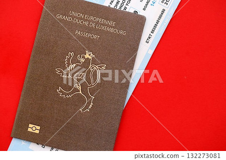 Luxembourg passport and commercial airlines boarding pass tickets close up. Travel flights and avia tourism in Europe concept 132273081