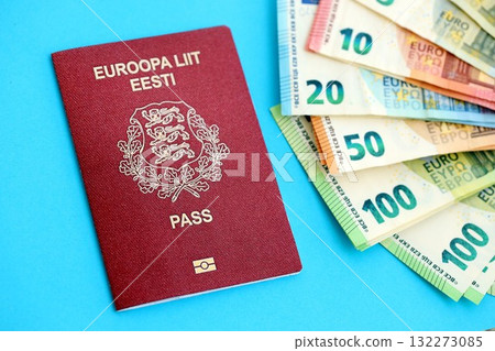 Estonia passport lies with euro money banknotes on blue background close up. Salary and pension in Europe concept Estonia passport lies with euro money banknotes on blue background close up. Salary and pension in Europe concept 132273085