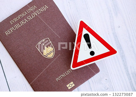 Slovenia passport with exclamation sign on white wooden background close up. Problems with citizenship in Europe concept Slovenia passport with exclamation sign on white wooden background close up. Problems with citizenship in Europe concept 132273087