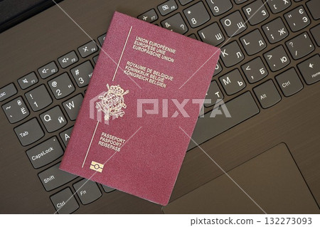 Belgium passport lies on black laptop keyboard buttons background close up. Technologies and control in Europe concept 132273093