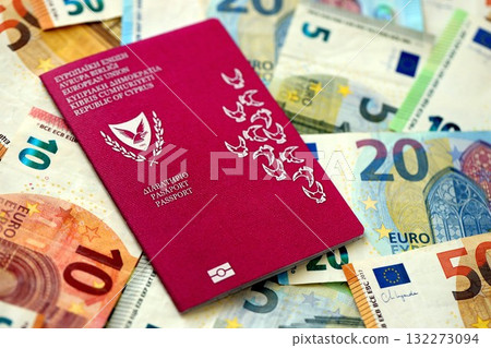Kyprus passport lies on big amount of euro money banknotes close up. Rich life and travel in Europe concept Kyprus passport lies on big amount of euro money banknotes close up. Rich life and travel in Europe concept 132273094