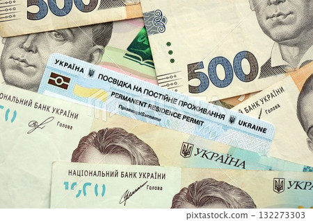 Ukrainian residence permit card or permanent resident card on Ukrainian money close up Ukrainian residence permit card or permanent resident card on Ukrainian money close up 132273303