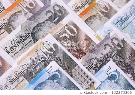 British pounds currency money bills in big amount. Many GBP currency banknotes with different denomination close up 132273306