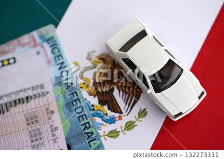 Mexican driving permit concept. Toy car and driver license on flag close up 132273311
