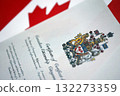 Canadian certificate of citizenship on Canadian flag close up 132273359