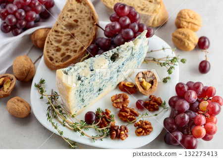 Gorgonzola cheese with walnuts, red grapes, and thyme. Gorgonzola cheese with walnuts, red grapes, and thyme. 132273413