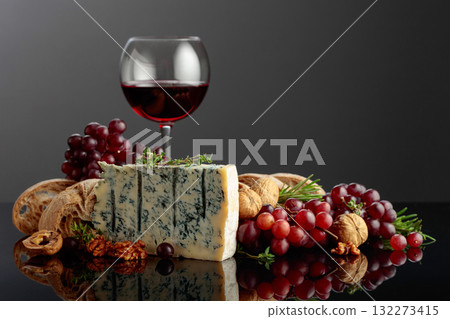 Gorgonzola cheese with ciabatta, walnuts, grapes, and red wine. 132273415