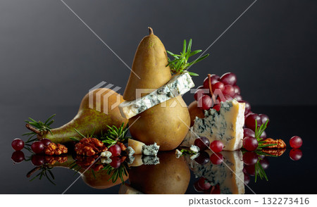 Blue cheese with pear, walnuts, red grapes, and rosemary. 132273416