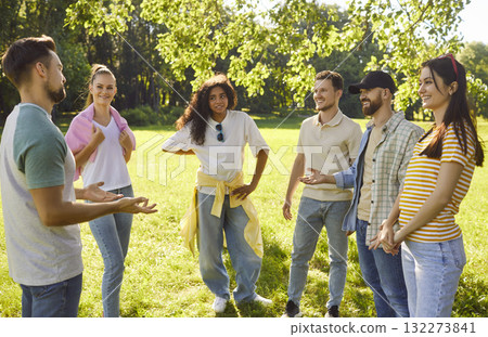 Friends gathering in sunny, green park, diverse group standing in circle, lively conversation Friends gathering in sunny, green park, diverse group standing in circle, lively conversation 132273841