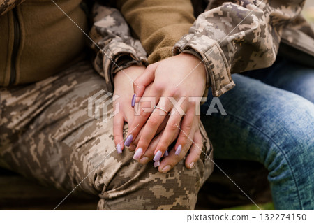 Romantic Hands Holding with Diamond Ring, Military Camouflage, Denim, Love, Partnership, Outdoors, Soft Focus, Warm Tones, Relationship Goals. Romantic Hands Holding with Diamond Ring, Military Camouflage, Denim, Love, Partnership, Outdoors, Soft Focus, Warm Tones, Relationship Goals. 132274150