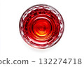 Overhead perspective of glass filled with vibrant red liquid showing bubbles, isolated against plain white background. Neural network AI generated 132274718