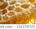 Close-up of golden honeycomb under warm lighting. Hexagonal cells filled with honey glisten, creating rich texture. Neural network AI generated 132274725