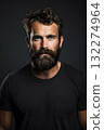 Man with beard and mustache in black tshirt, dark background 132274964