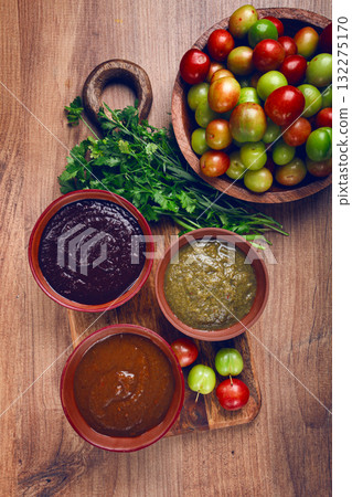 set of tkemali sauces, three types of tkemali sauce, in ceramic bowls, top view, Georgian cuisine, no people, 132275170