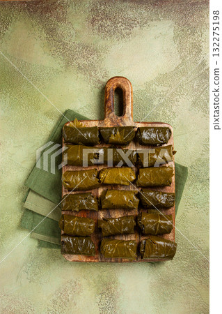 dolma, minced meat with rice, in grape leaves, minced meat rolls, on a chopping board, top view, no people, 132275198