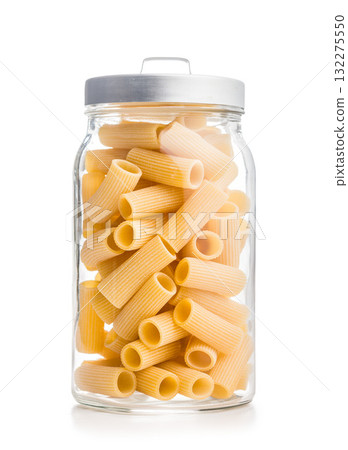 Uncooked rigatoni pasta in jar isolated on white background. Uncooked rigatoni pasta in jar isolated on white background. 132275550