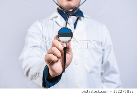 Doctor hands holding stethoscope with Estonia flag. Estonia health and care concept 132275852
